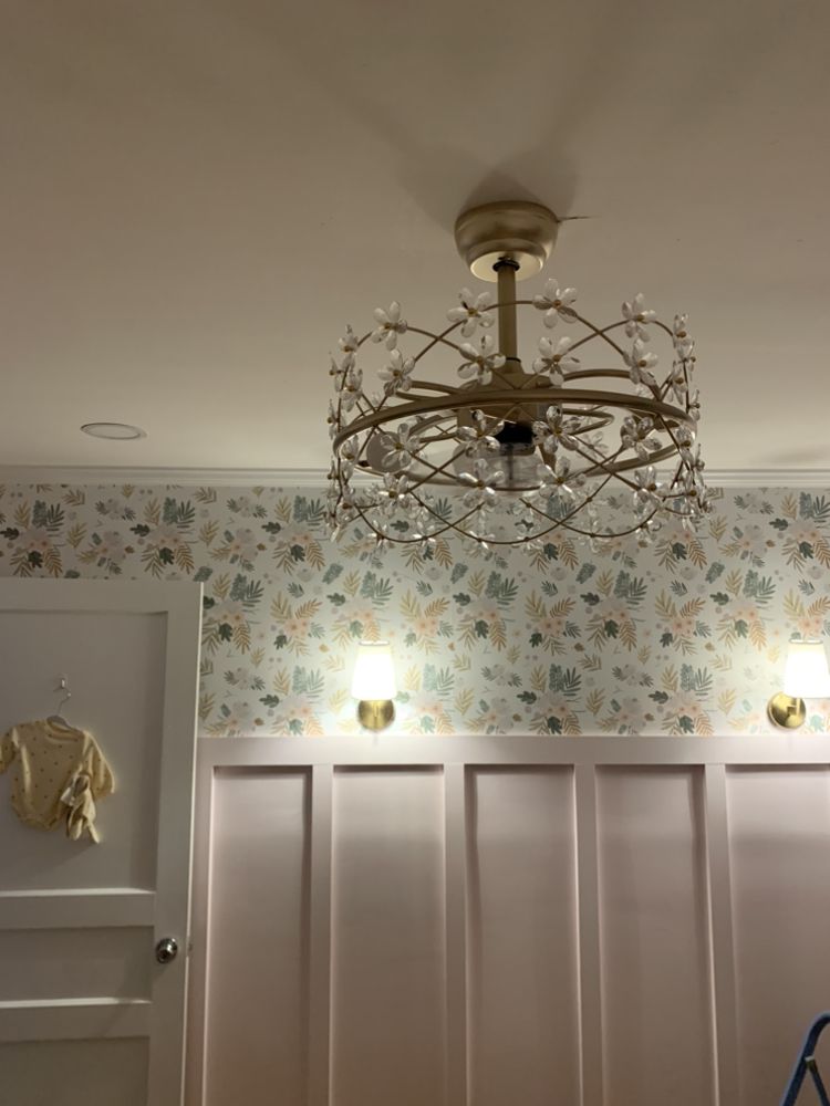 Ceiling fan, chandelier, and sconces installed in a nursery